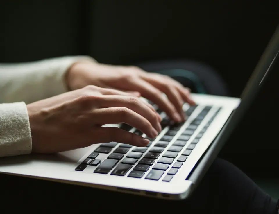 a person typing on a laptop
