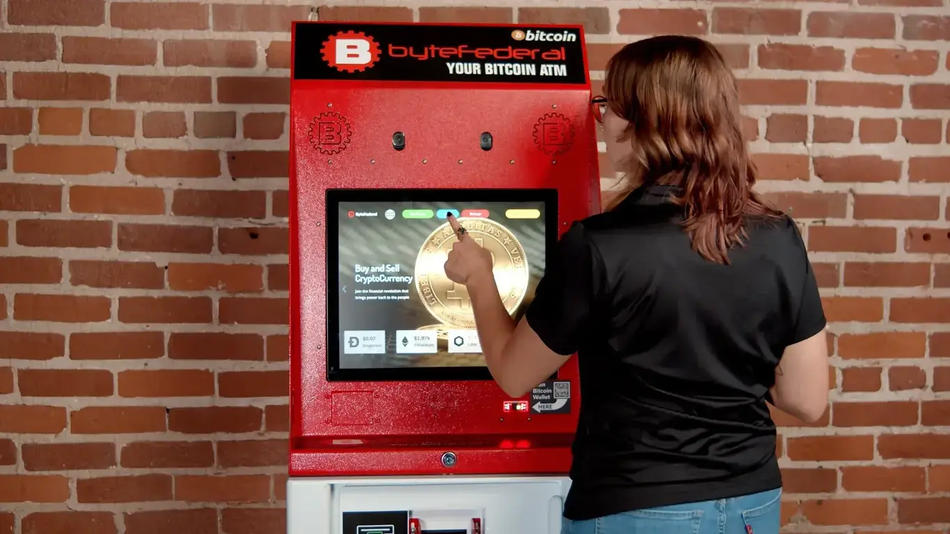 Woman using Byte Federal bitcoin ATM