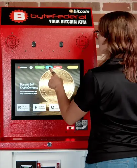 Woman using Byte Federal bitcoin ATM