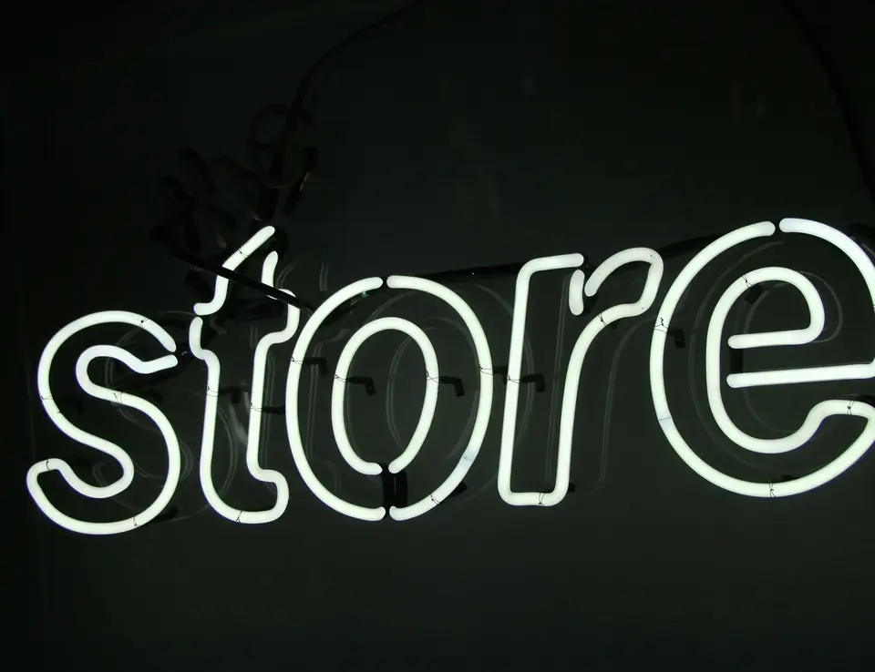 Neon white light displaying the word 'store'