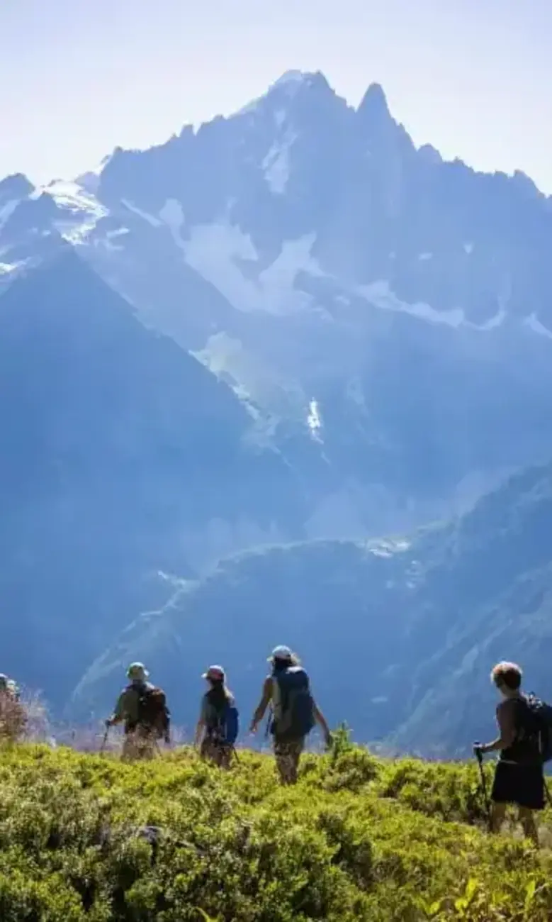 a group of people hiking in the mountains