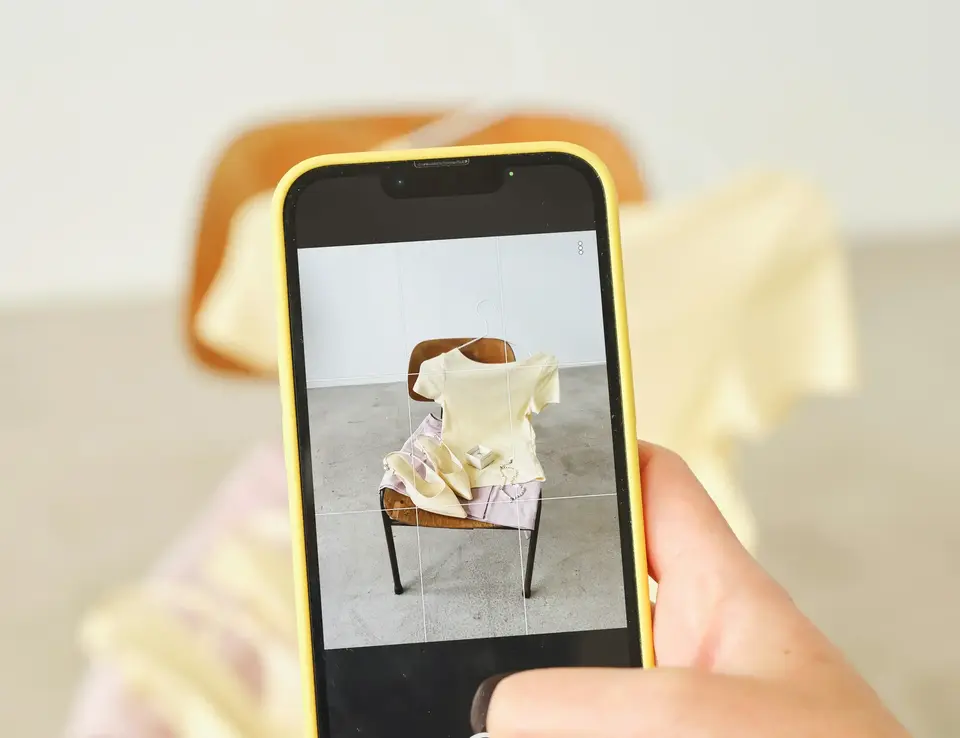 a person taking a picture of a chair