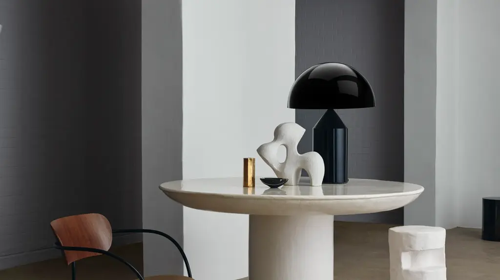 a table with a black lamp and a chair