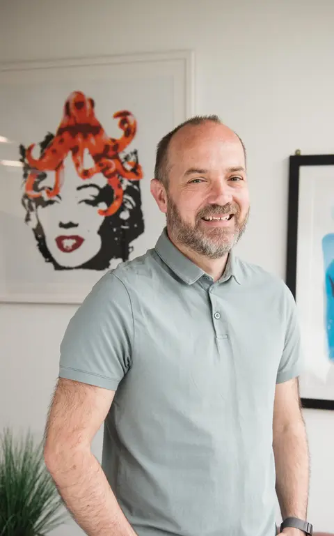 a man standing in front of a picture