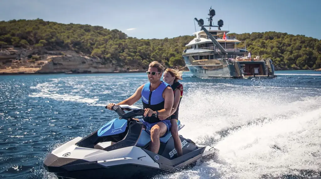 a man and woman on a jet ski