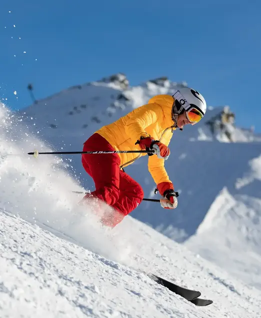 a person skiing down a snowy hill