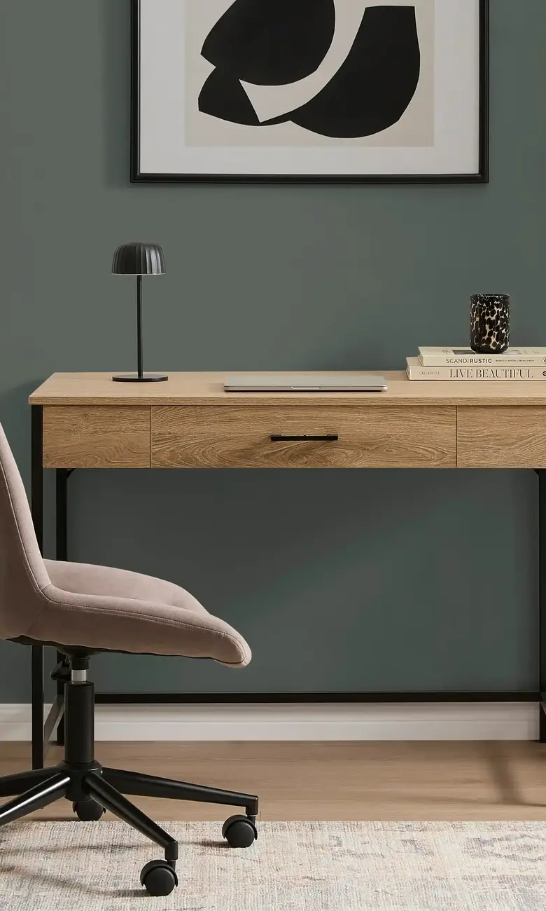 a desk with a chair and a picture on the wall