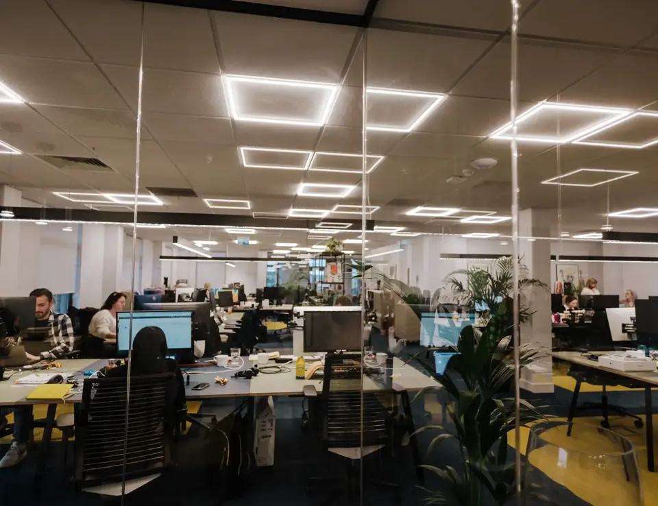 a group of people working at computers in an office