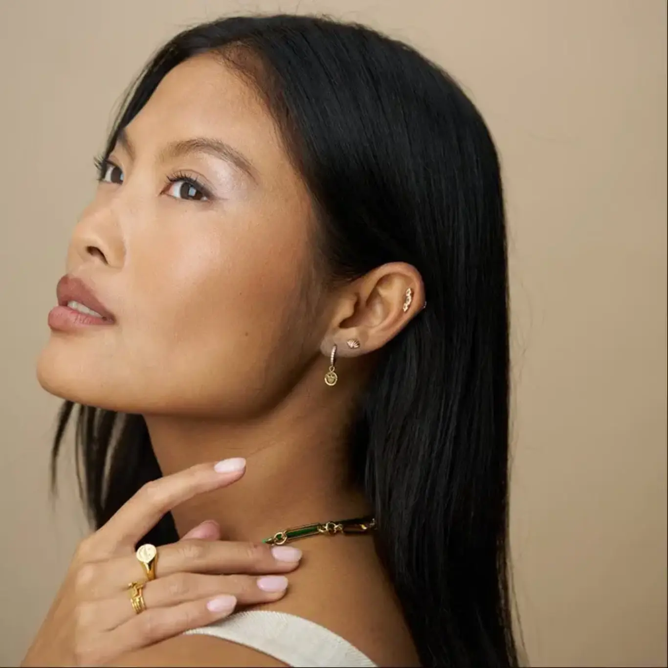 Model wearing gold hoop earrings