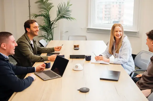 a group of people sitting around a table