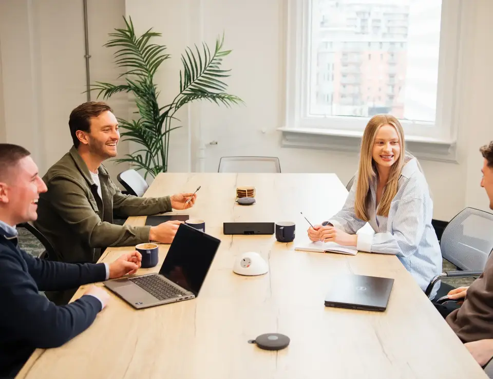 a group of people sitting around a table
