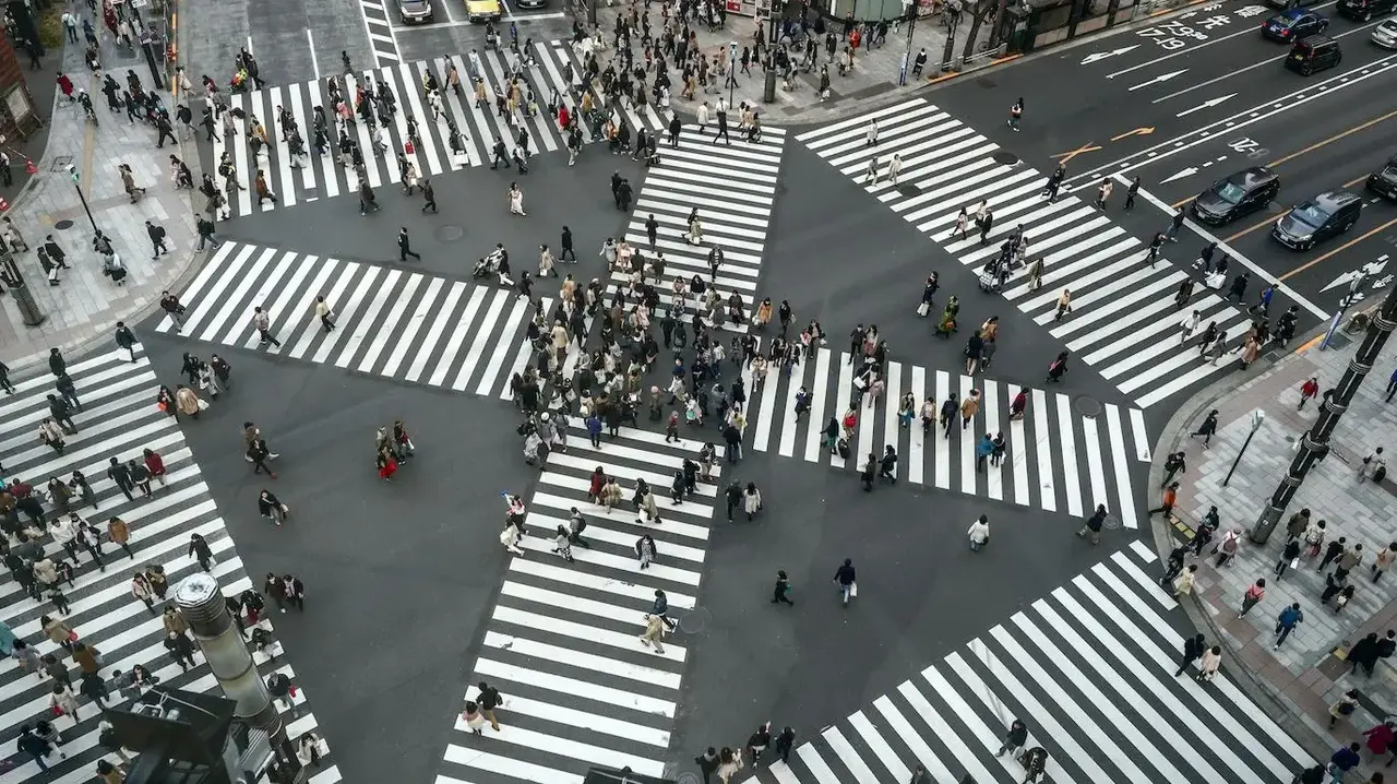 a group of people crossing a street