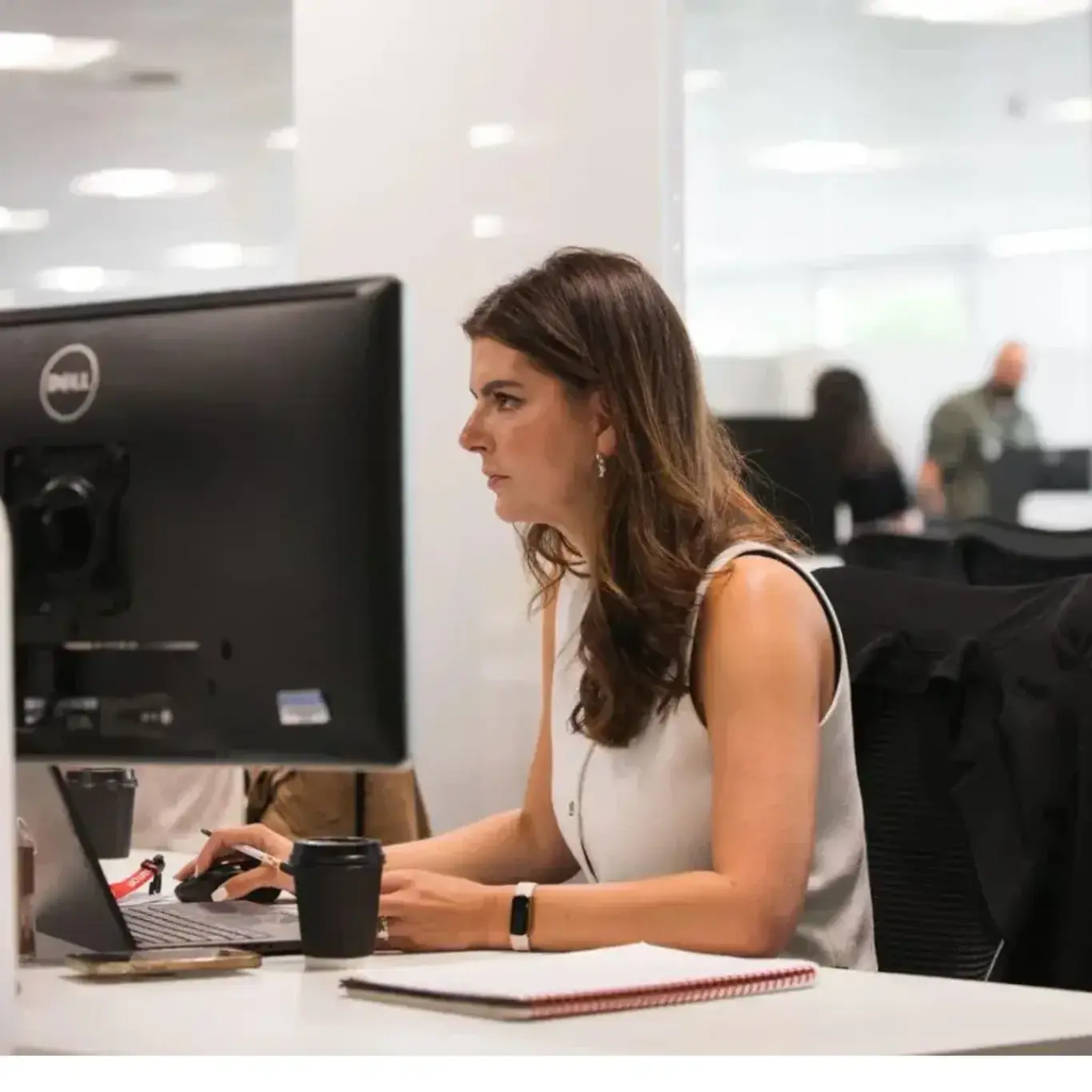 a woman sitting at a desk using a computer