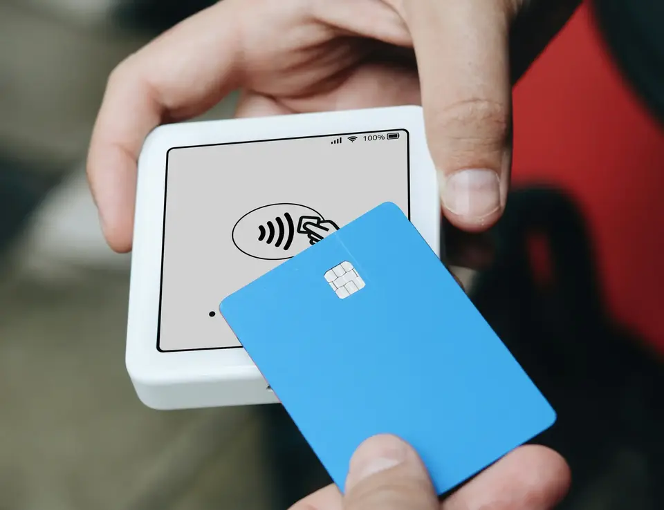 a person holding a blue card
