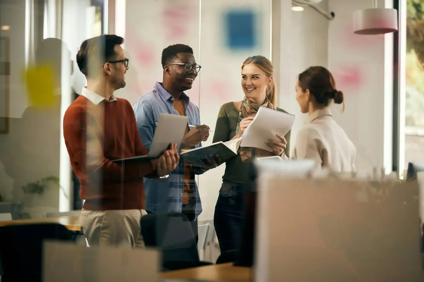 a group of people standing around a glass wall