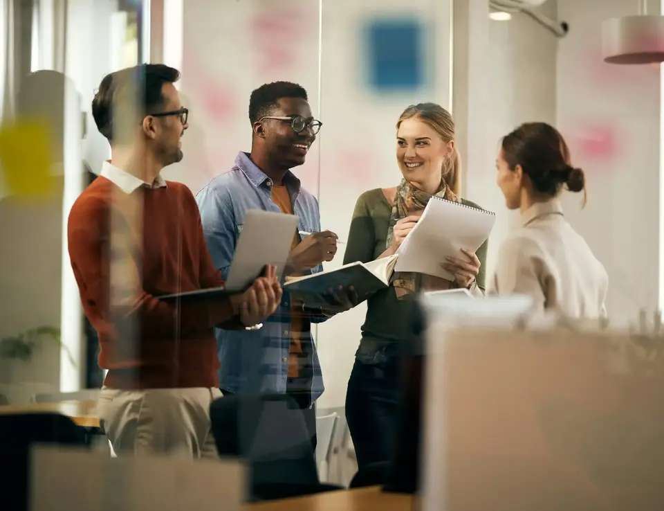 a group of people standing around a glass wall