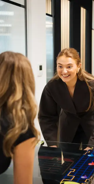 a woman smiling at another woman