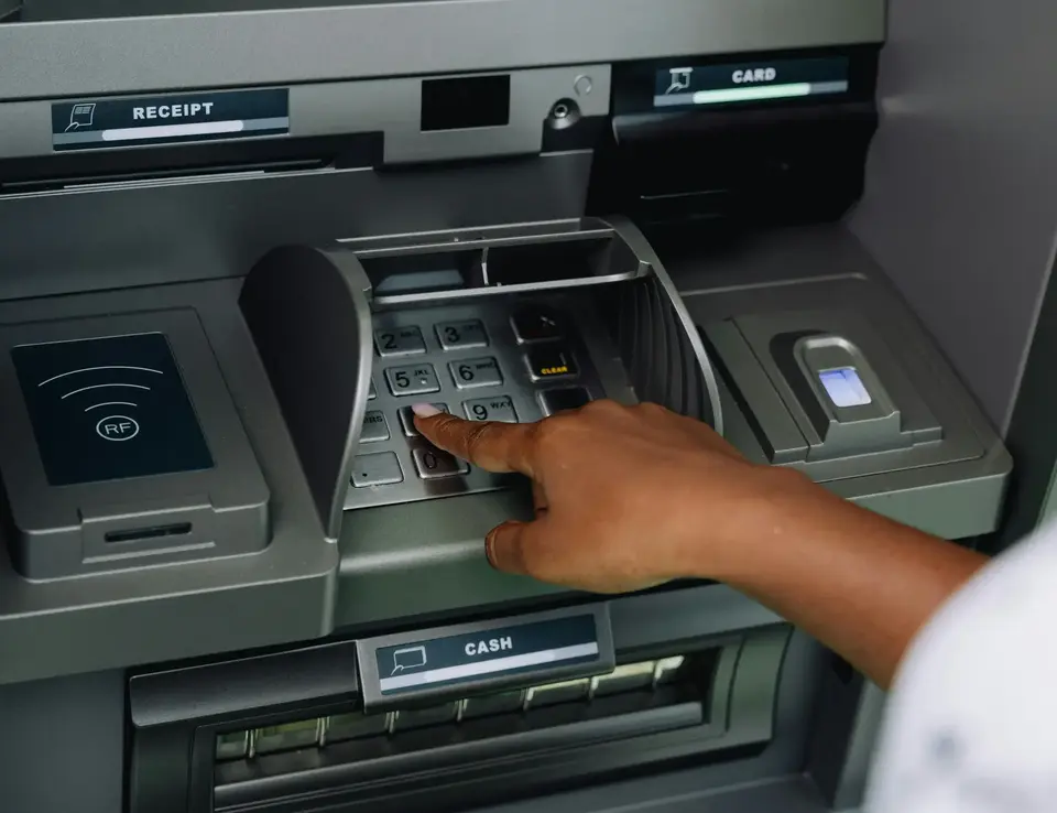 Person stood at a bank ATM