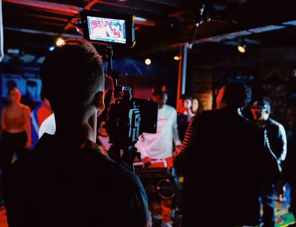 a man with a camera on a tripod