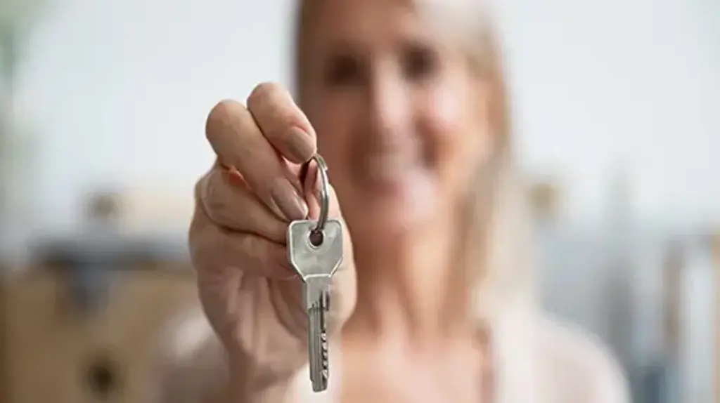 a woman holding a key