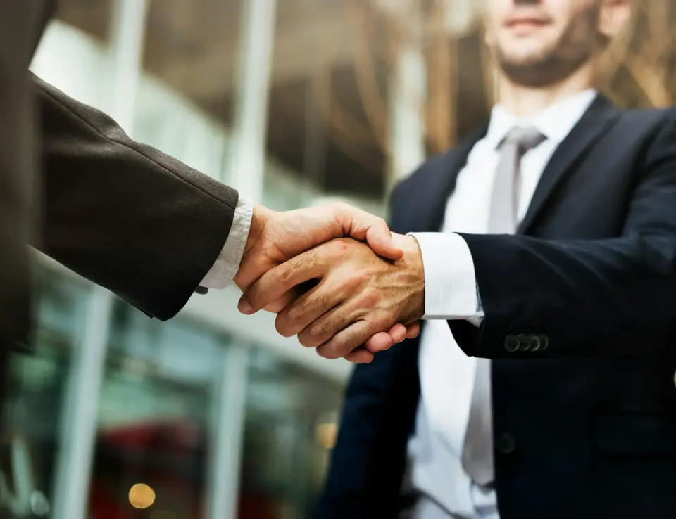 Two men in suits shaking hands