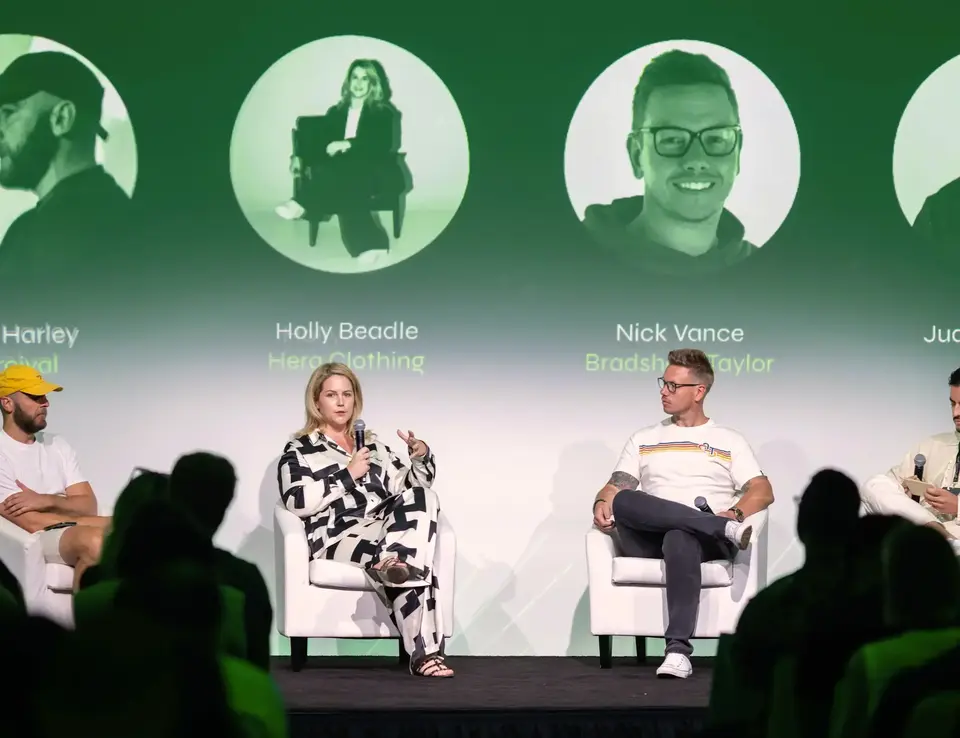 a man and woman sitting on a stage