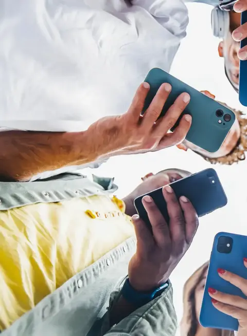 a group of people holding cell phones