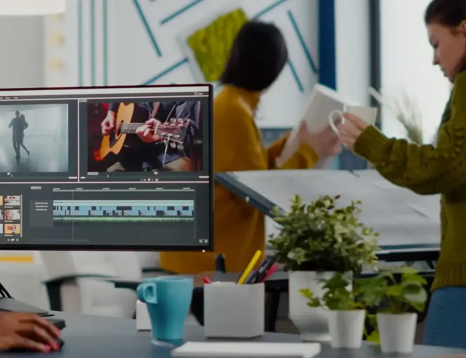 a woman sitting at a desk with a computer