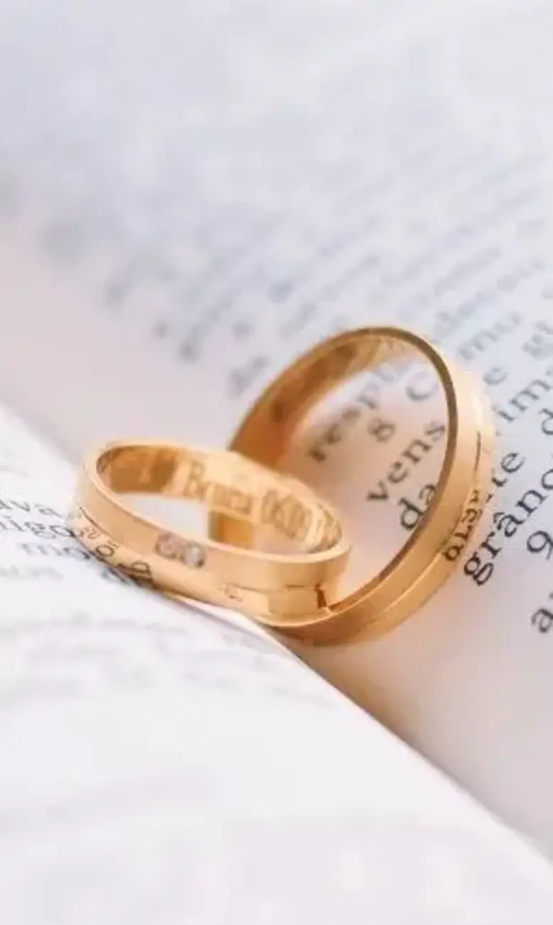 two gold rings on a book