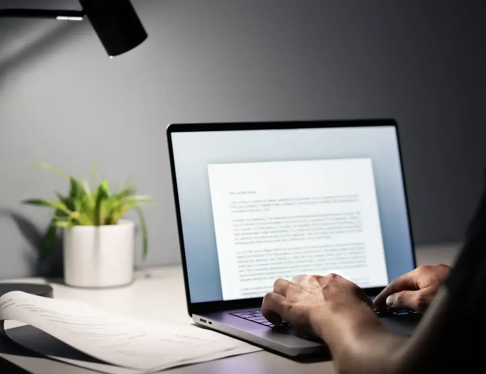 a person typing on a laptop