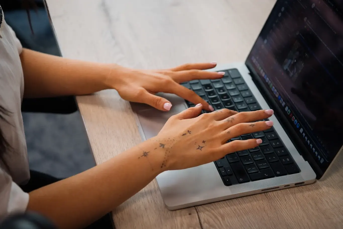 a person's hands on a laptop keyboard