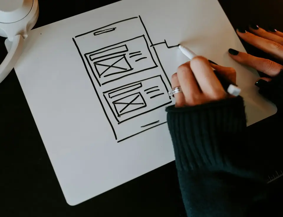 a person drawing a sketch on a piece of paper