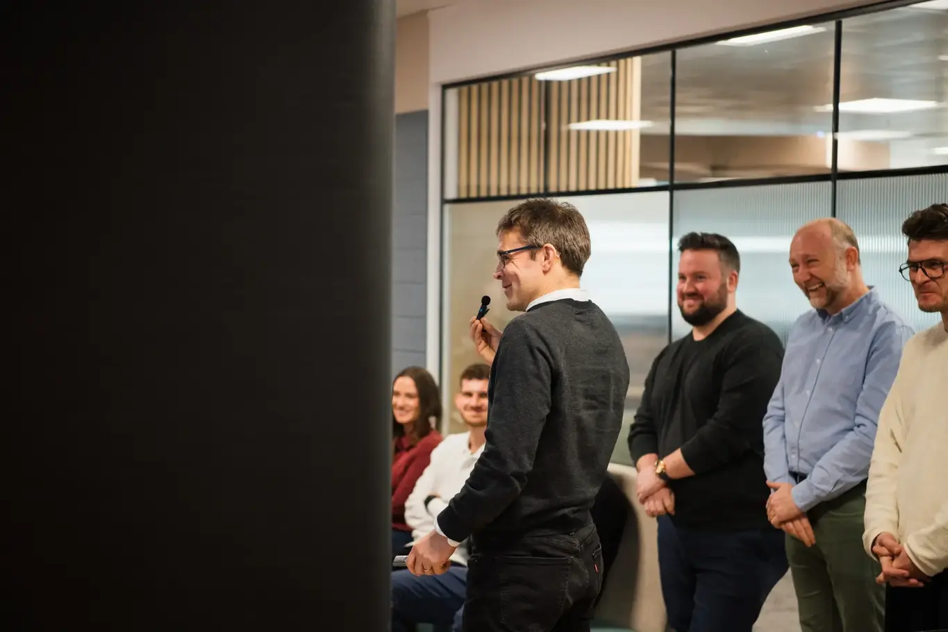 a group of people standing in front of a window