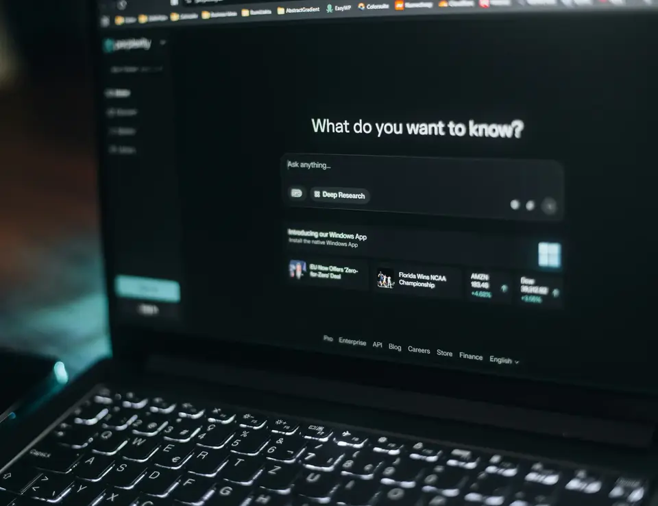 Open laptop with ChatGPT interface asking 'What do you want to know?'