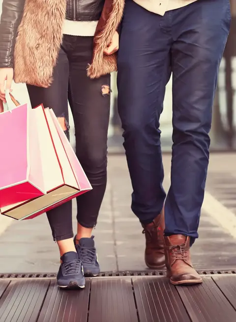 a man and woman holding shopping bags