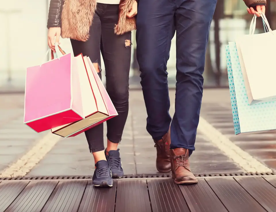 a man and woman holding shopping bags