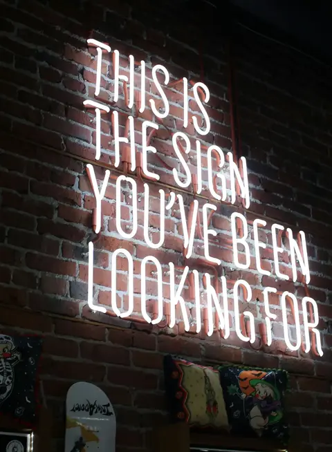 a sign on a brick wall