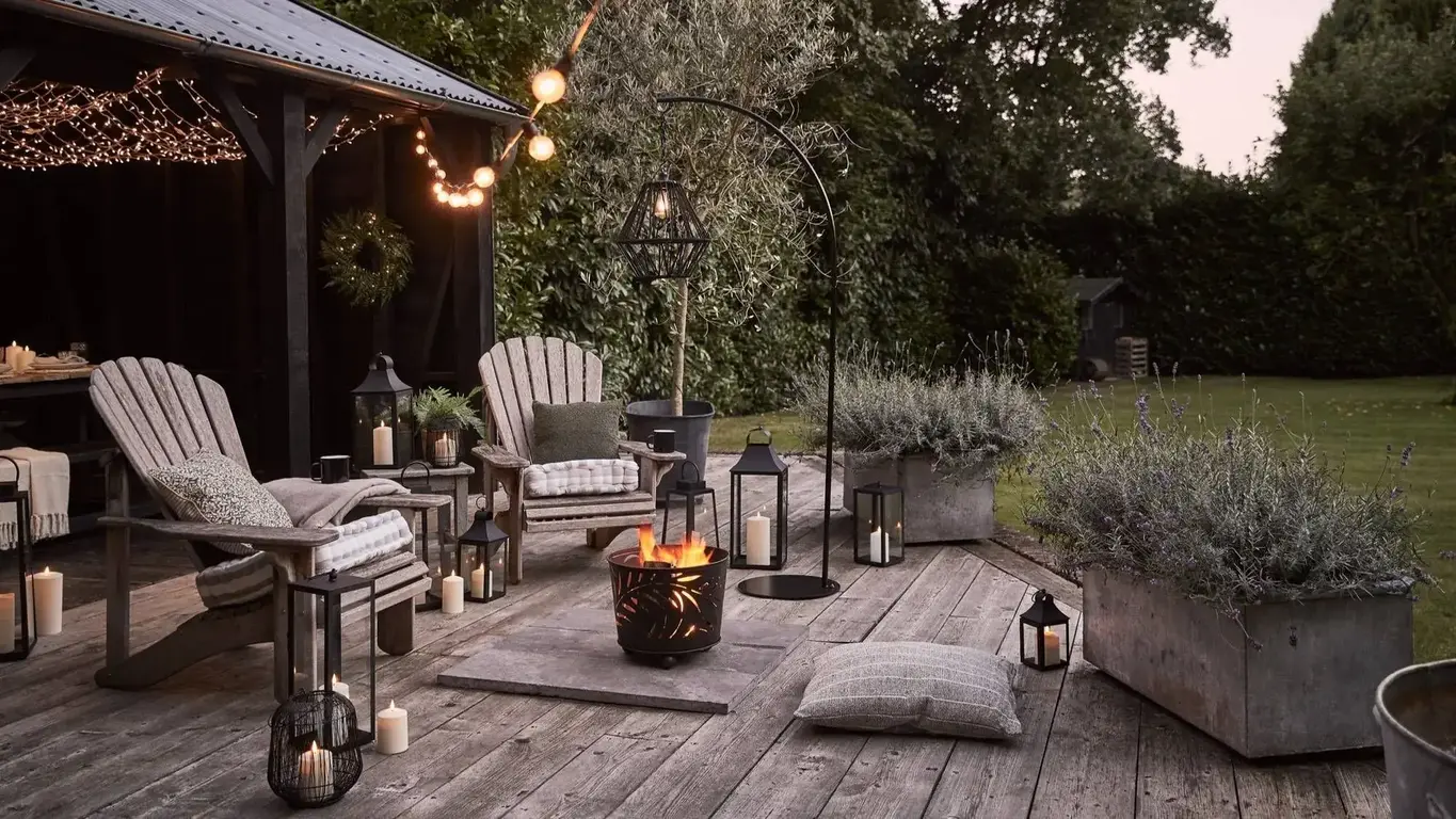 a patio with a fire pit and chairs