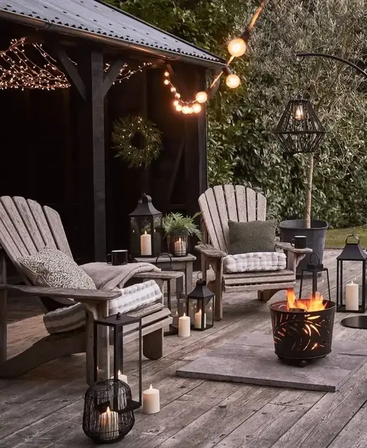 a patio with a fire pit and chairs