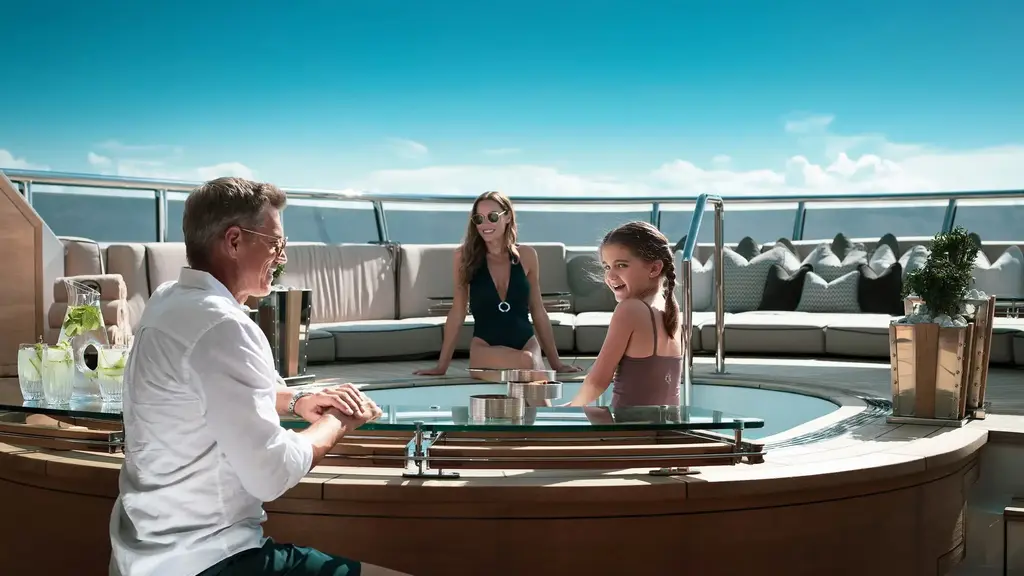 a man and two girls sitting on a boat