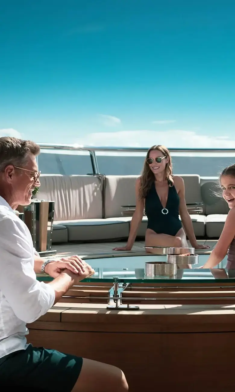 a man and two girls sitting on a boat