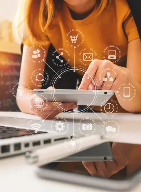 a woman using a tablet and a laptop