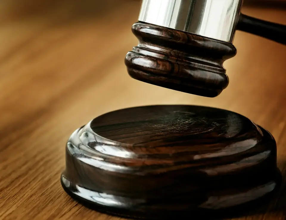 a gavel on a wooden surface