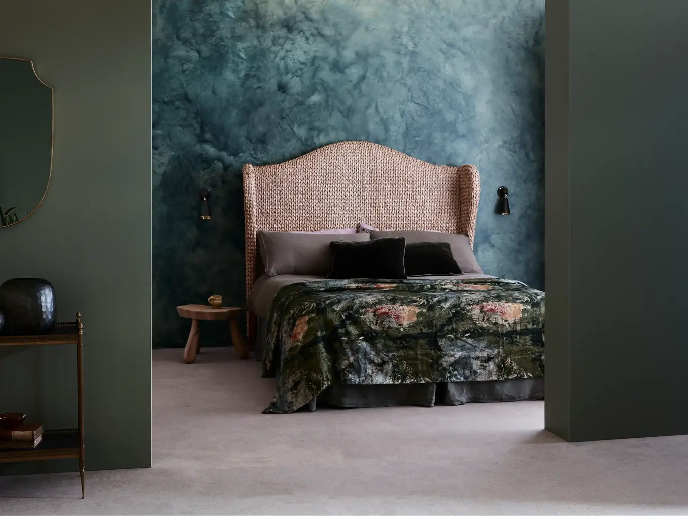 a bed with a wicker headboard and a table