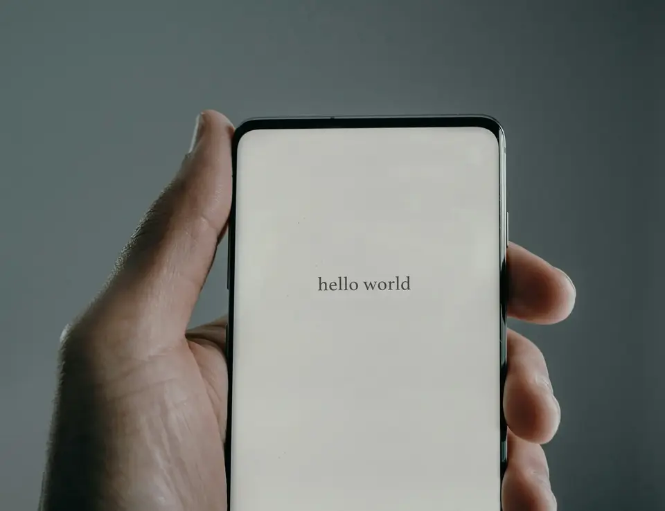 a hand holding a cell phone