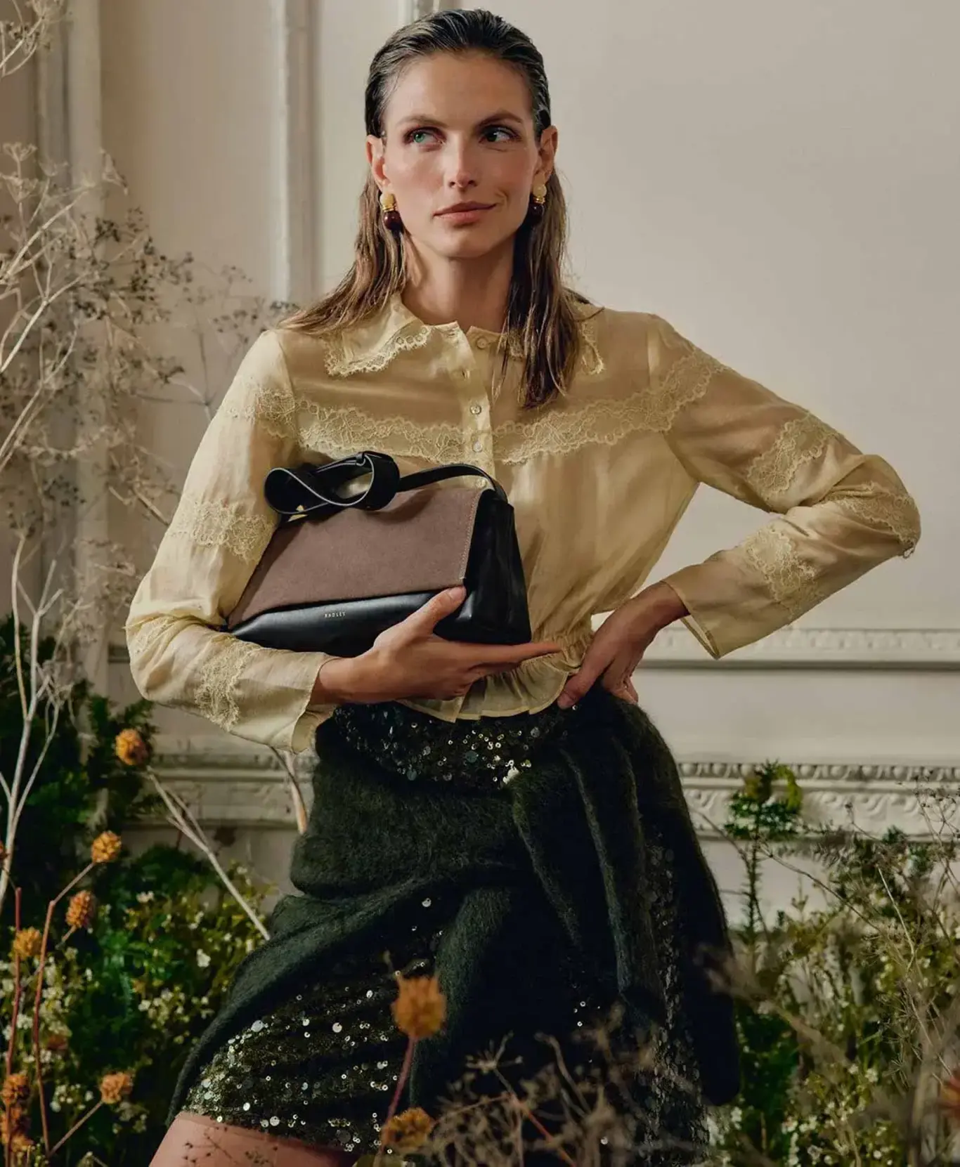 Model holding brown Radley handbag