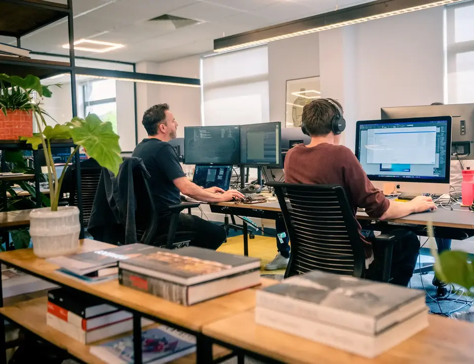 a group of men sitting at computers