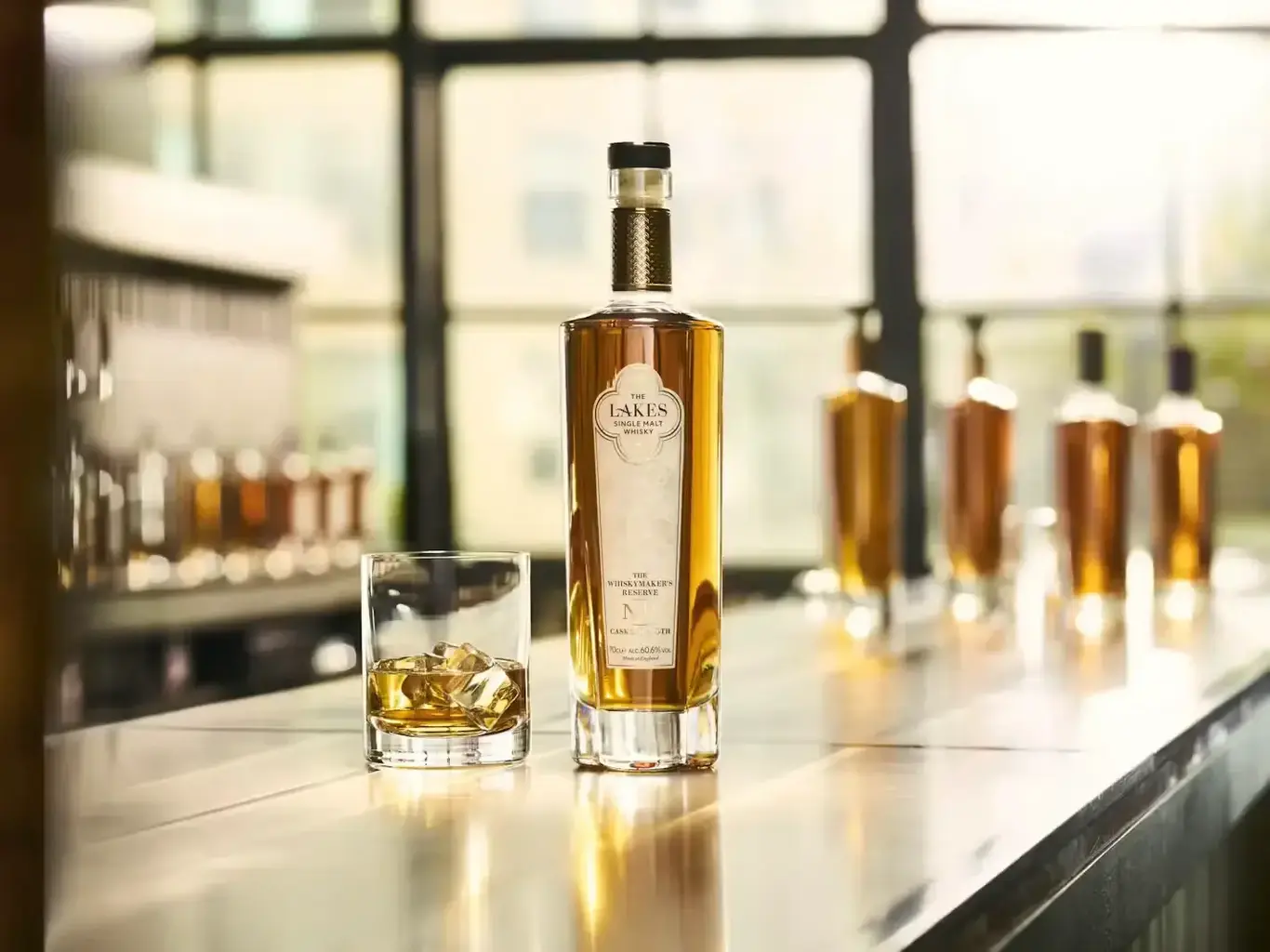 a bottle of alcohol next to a glass of ice