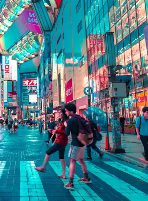 People crossing zebra crossing in a neon lit shopping mall 
