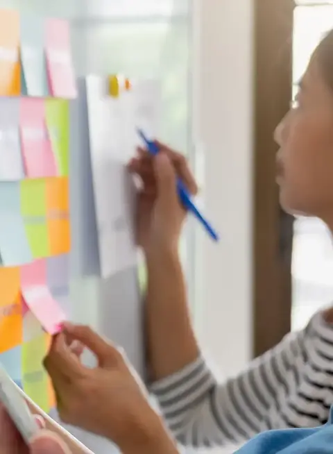 a group of people holding sticky notes